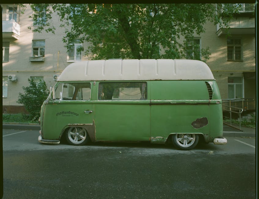Retro green van with a classic design parked outdoors, showcasing vintage charm.